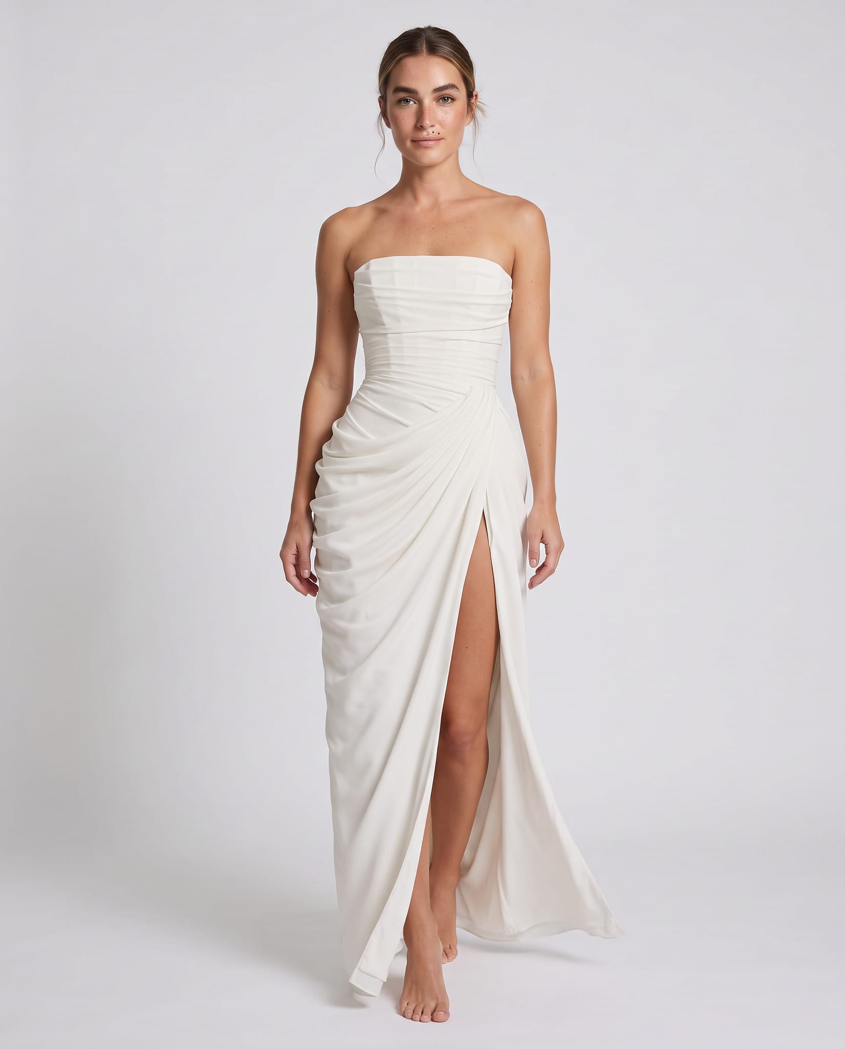 Cyra Maxi Dress Ivory – model walking pose, light gray studio