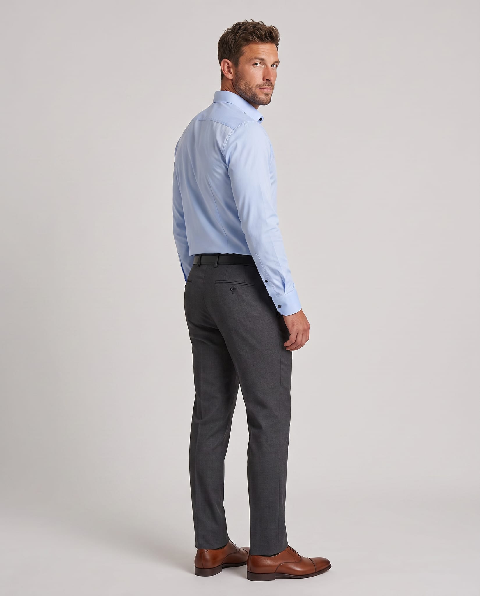 Men's Stretch Wrinkle-Free Dress Shirt – model back view over shoulder, light gray studio