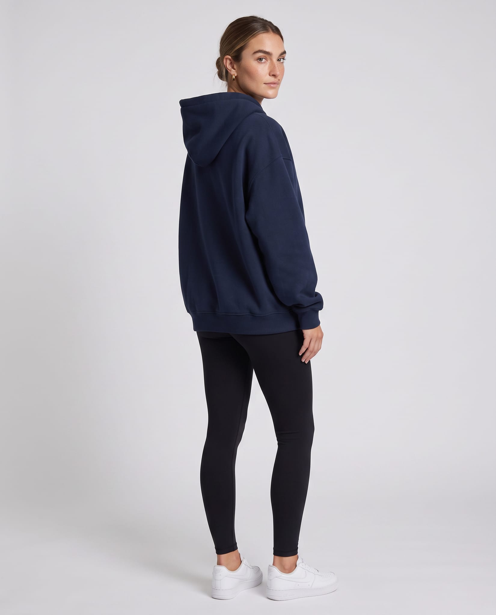 Women's Oversized Everyday Hoodie – model back view over shoulder, light gray studio