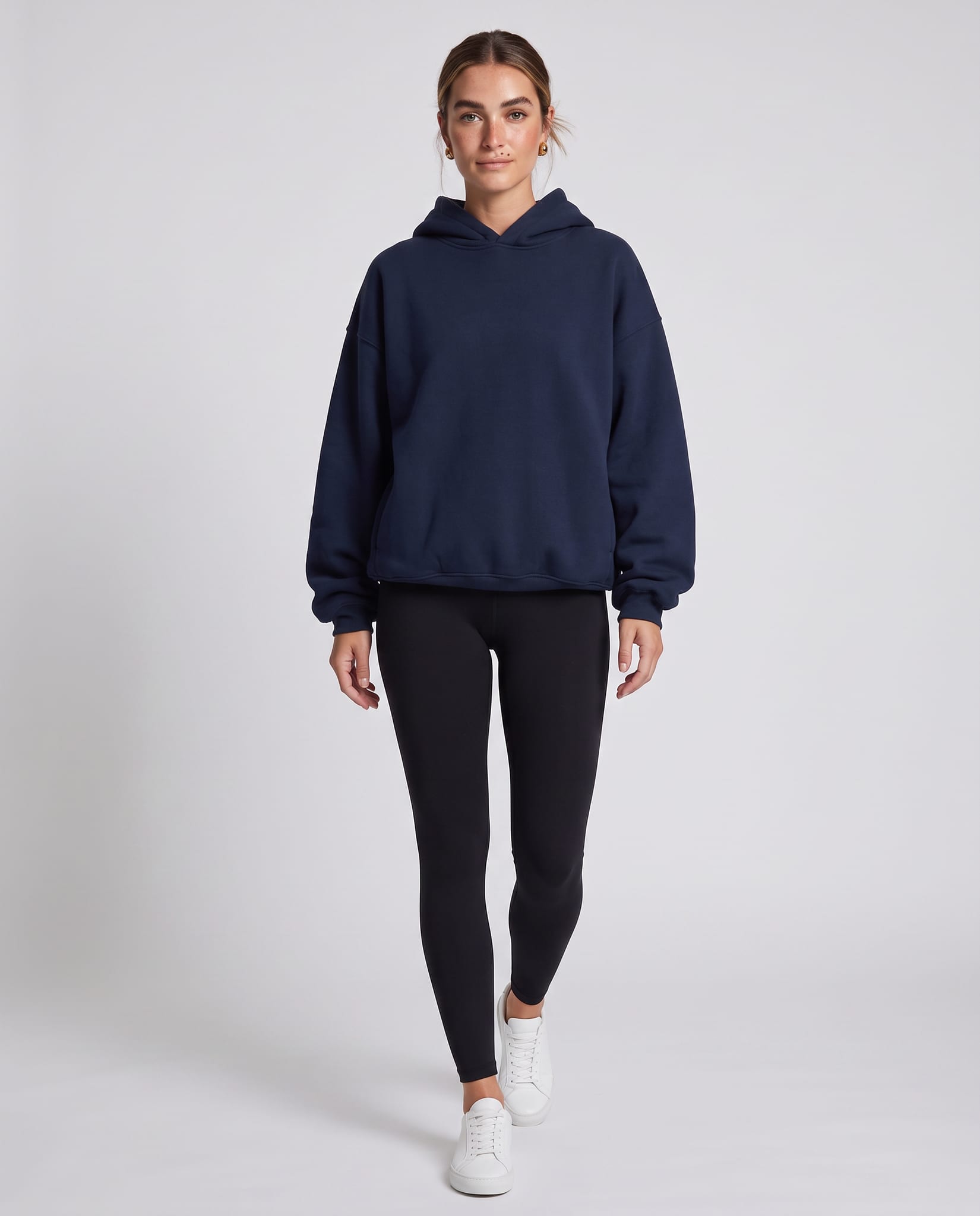 Women's Oversized Everyday Hoodie – model walking pose, light gray studio