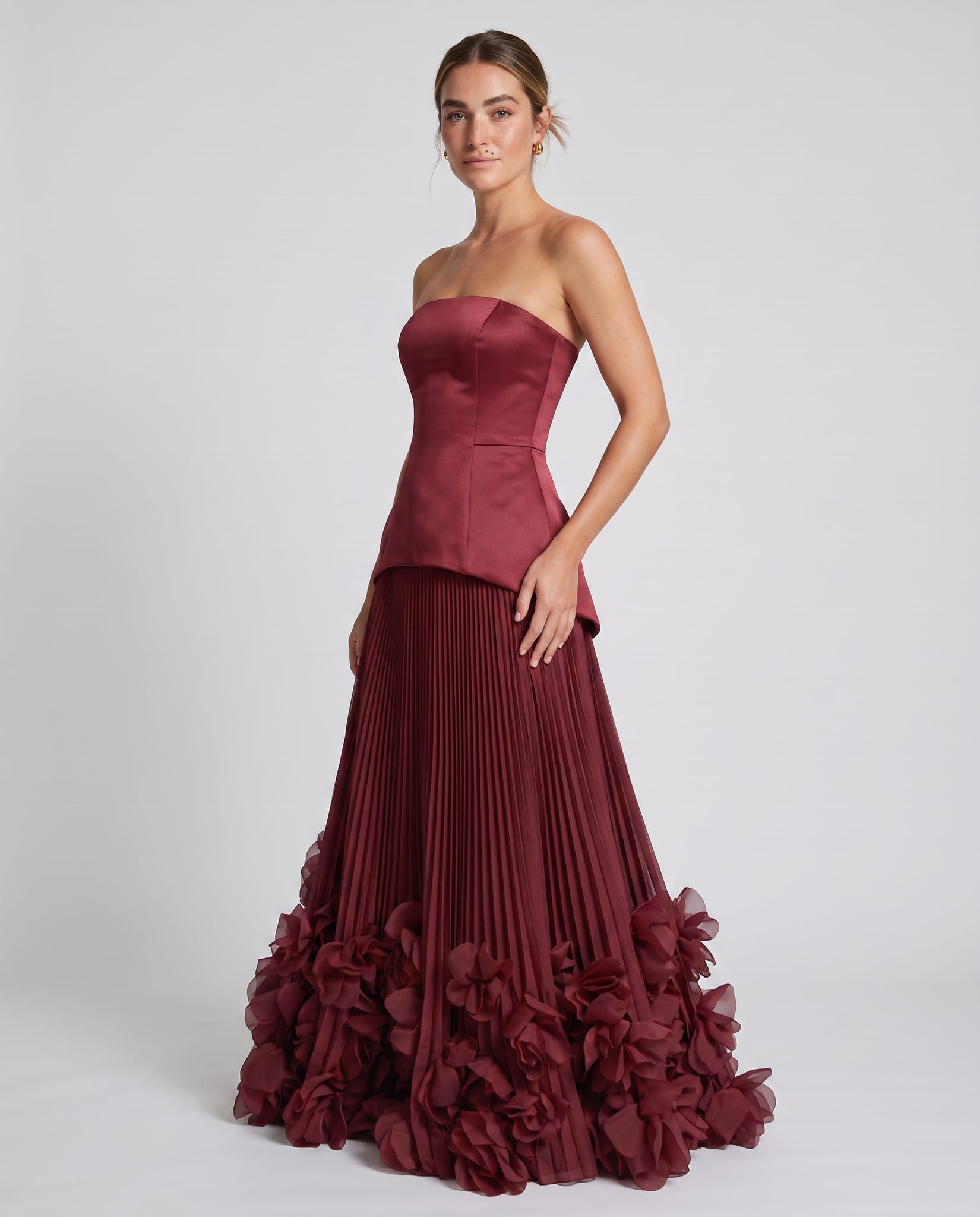Seraphina Gown Cherry Lacquer – model three-quarter view, light gray studio
