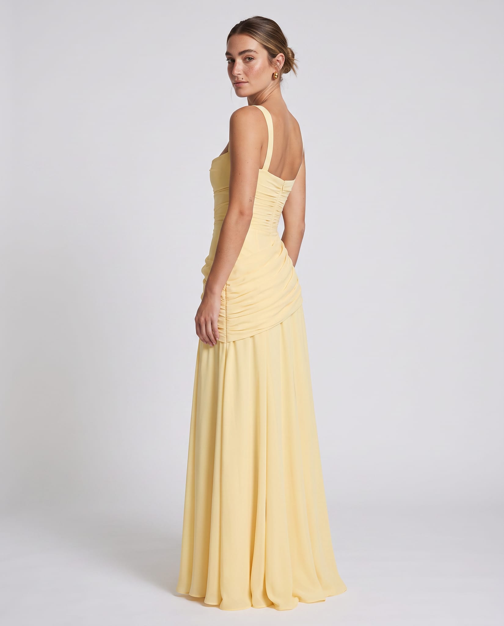 Sura Maxi Dress Lemon – model back view over shoulder, light gray studio