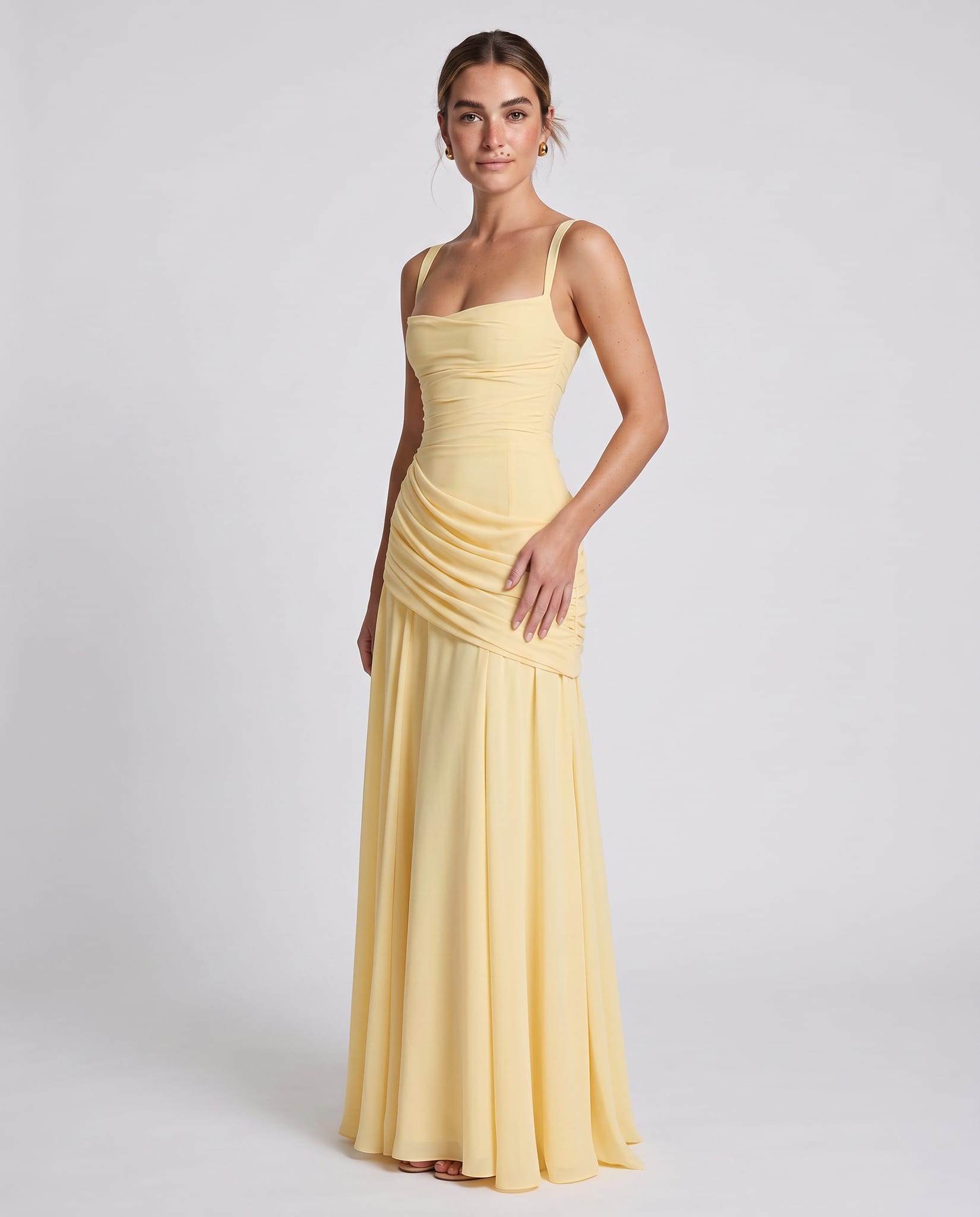 Sura Maxi Dress Lemon – model three-quarter view, light gray studio