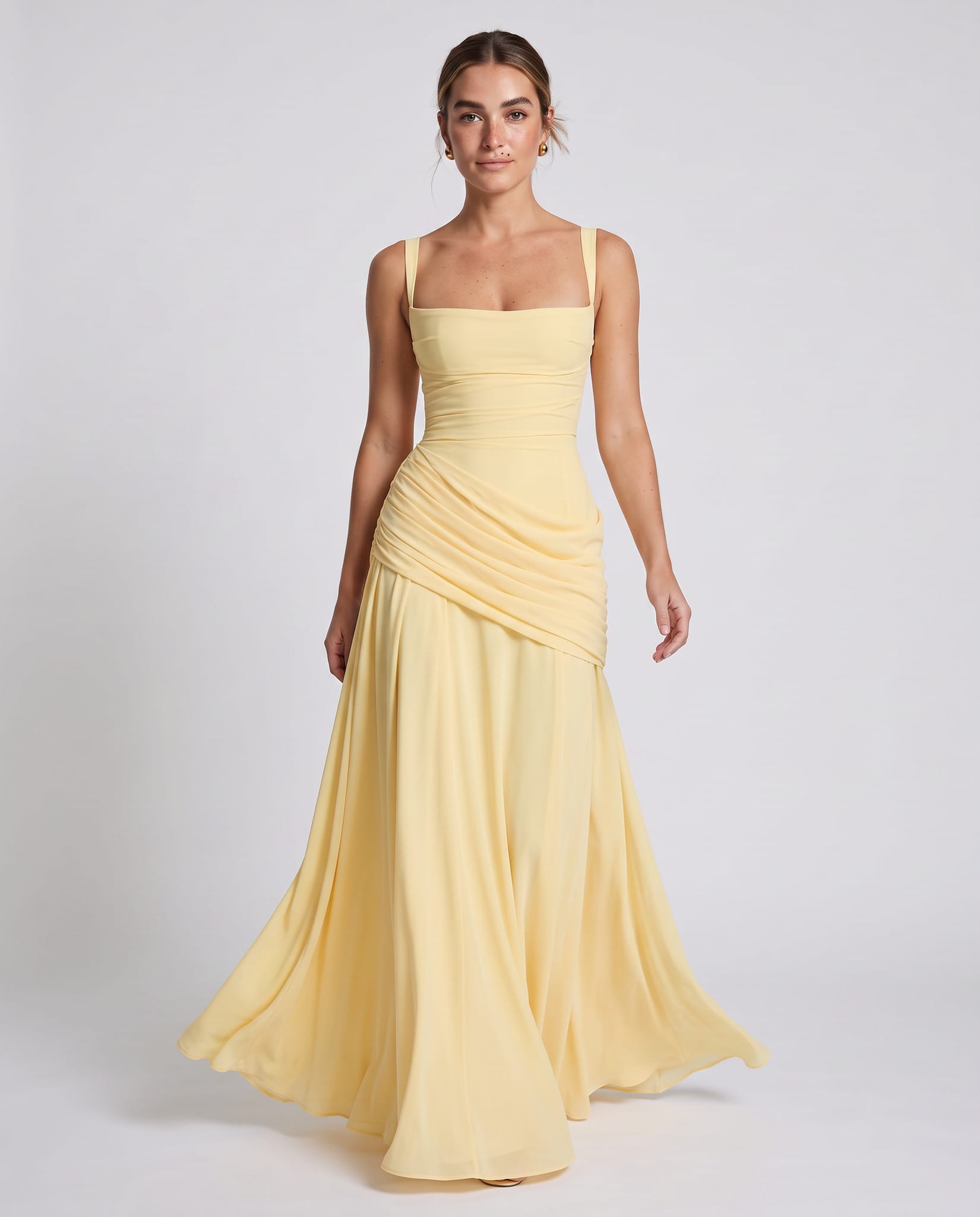 Sura Maxi Dress Lemon – model walking pose, light gray studio